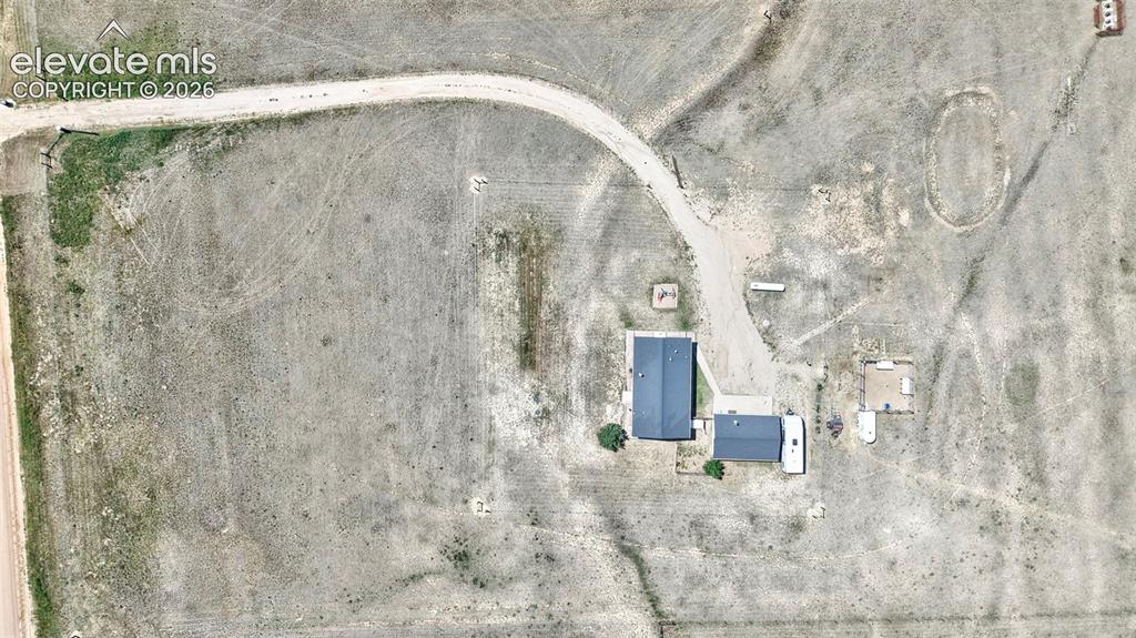 Image 36 of 36: Property featuring two structures, a winding driveway, and a distinct oval-