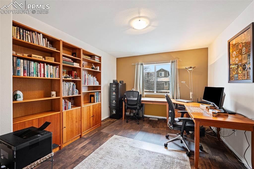 Image 9 of 30: Office with built in bookshelves that can also be used as a third bedroom