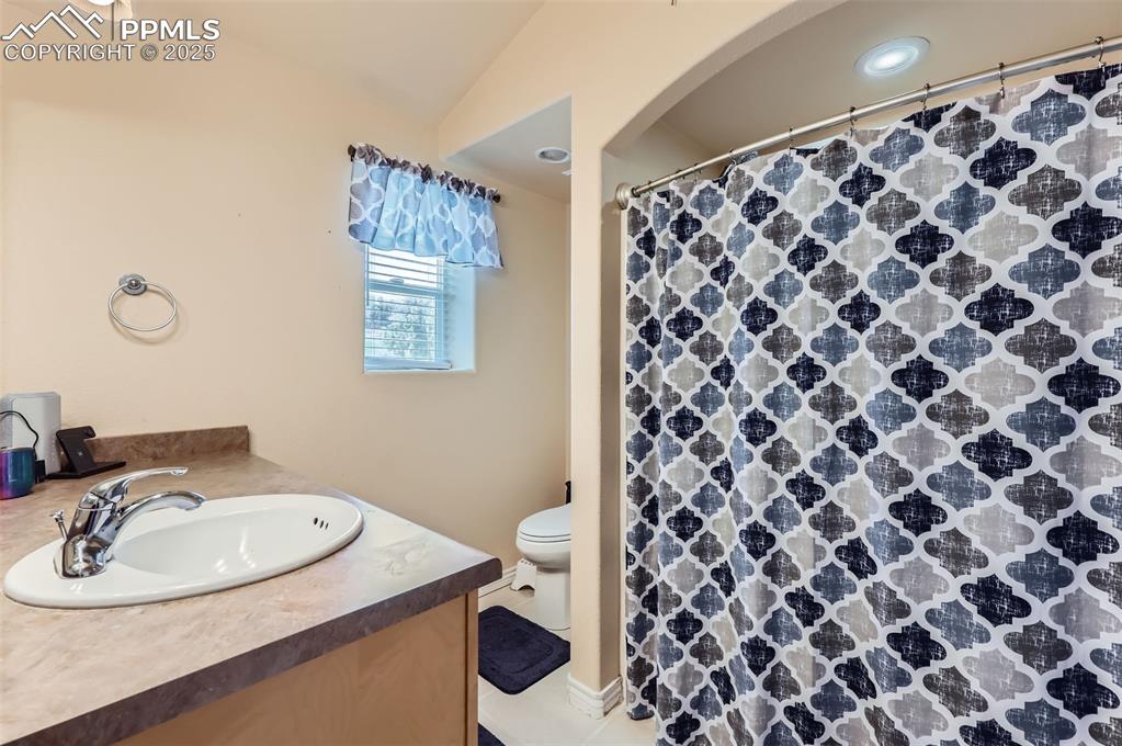 Image 16 of 29: Full bath featuring vanity and a shower with shower curtain