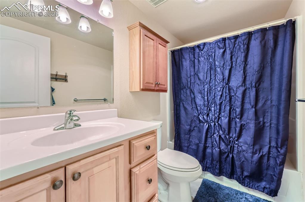 Image 27 of 29: Full bath with shower / bath combo and vanity