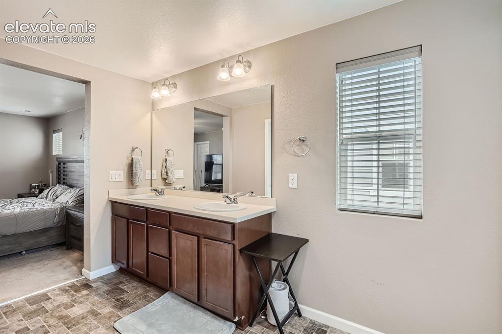 Image 17 of 28: Glass-enclosed shower with white subway tile surround, featuring a shower h