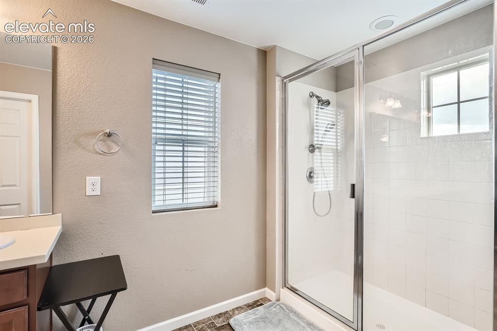 Image 18 of 28: Carpeted room featuring a ceiling fan with integrated lighting, a window wi