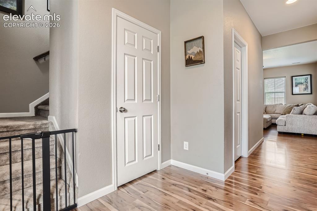 Image 4 of 28: Hardwood-finish flooring extending from the entryway into other living spac