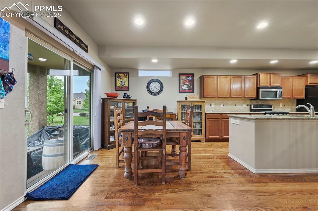 Image 14 of 50: Kitchen featuring appliances with stainless steel finishes, light wood-type