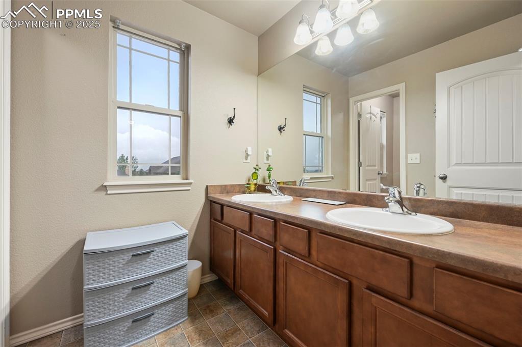 Image 25 of 50: Full bathroom featuring plenty of natural light and double vanity
