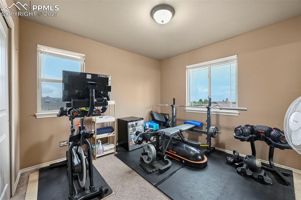 Image 27 of 50: Workout room featuring baseboards