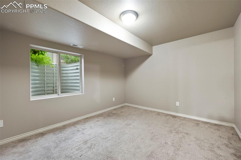 Image 34 of 50: Additional living space with carpet and baseboards