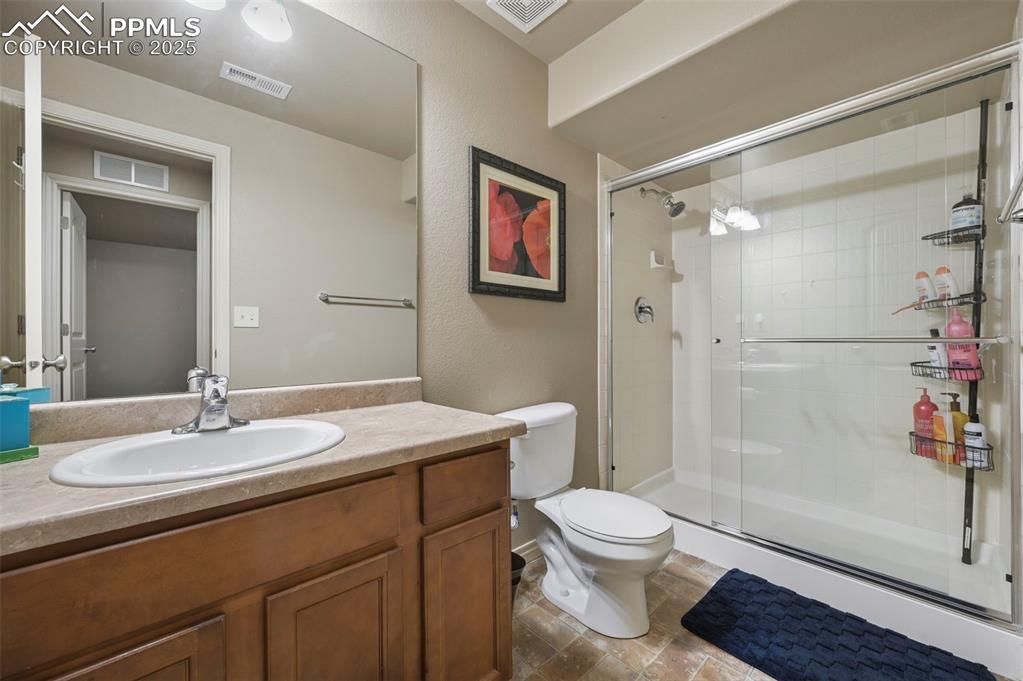 Image 35 of 50: Bathroom featuring a stall shower and vanity
