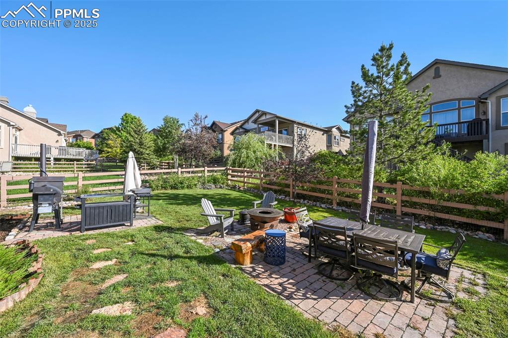 Image 39 of 50: View of yard featuring a fire pit, a patio, and a residential view