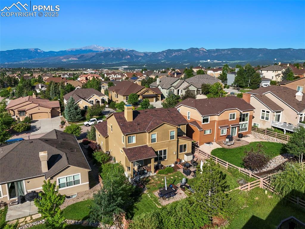 Image 44 of 50: Aerial view of residential area with a mountain backdrop