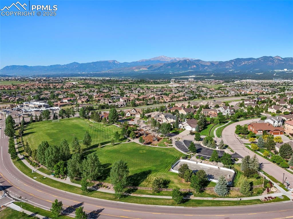 Image 47 of 50: Aerial view of property and surrounding area with a mountainous background 