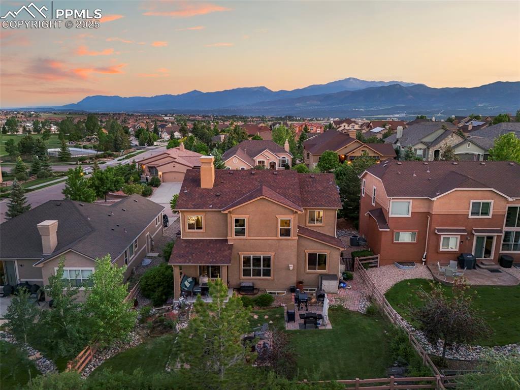 Image 50 of 50: Aerial view at dusk of a residential view and a mountain view
