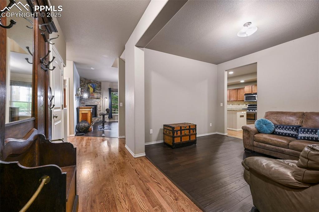 Image 6 of 50: Living area with dark wood-type flooring and a fireplace