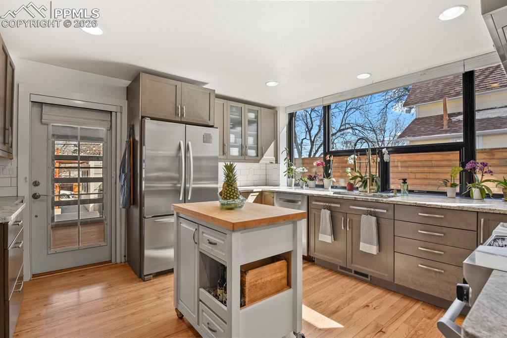 Image 16 of 50: Gourmet kitchen with ceiling to counter modern windows 