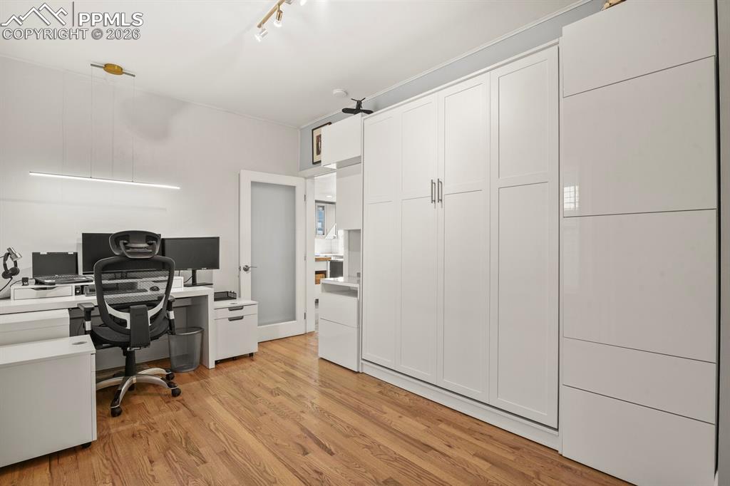 Image 21 of 50: Main level bedroom with built-in murphy bed and additonal storage 