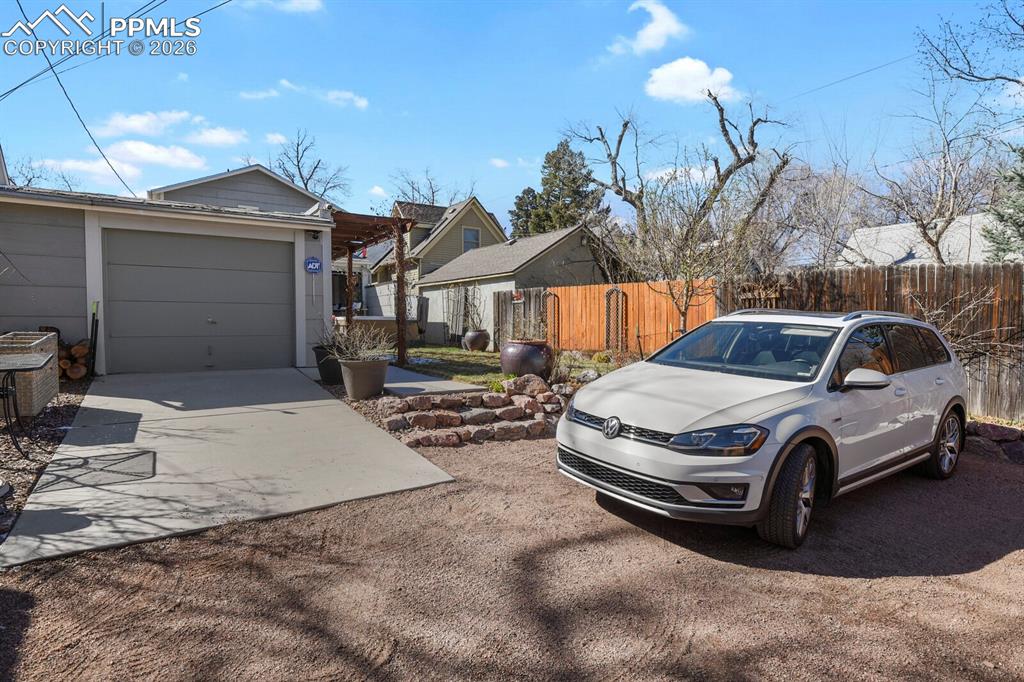 Image 43 of 50: Back of yard with plenty of additonal parking and a one car deatched garage