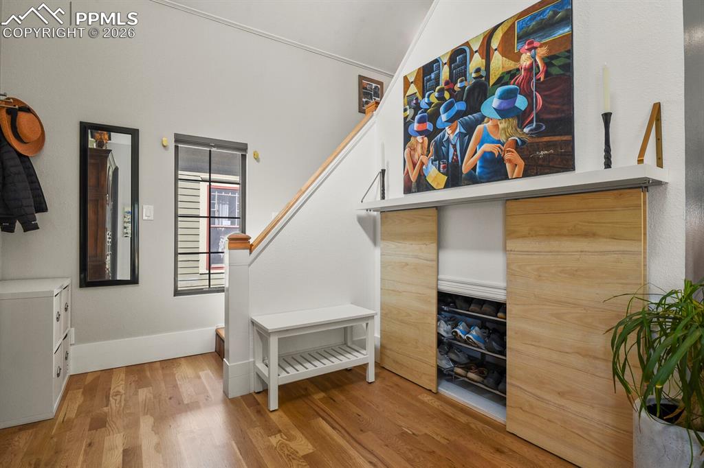 Image 5 of 50: Front foyer with storage closet underneath the stairs for shoes
