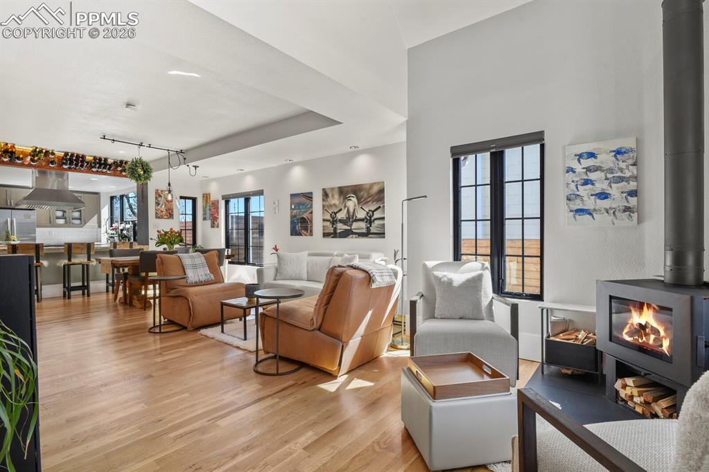 Image 6 of 50: Stunning open living room with wood burning fireplace 