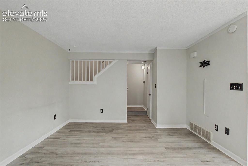 Image 7 of 30: 1/2 bath on the right of the stairs with closet underneath stairs on the le