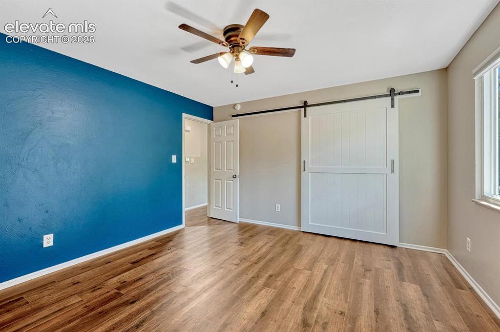 Image 10 of 29: Interior space featuring wood-finish flooring, a ceiling fan with light fix