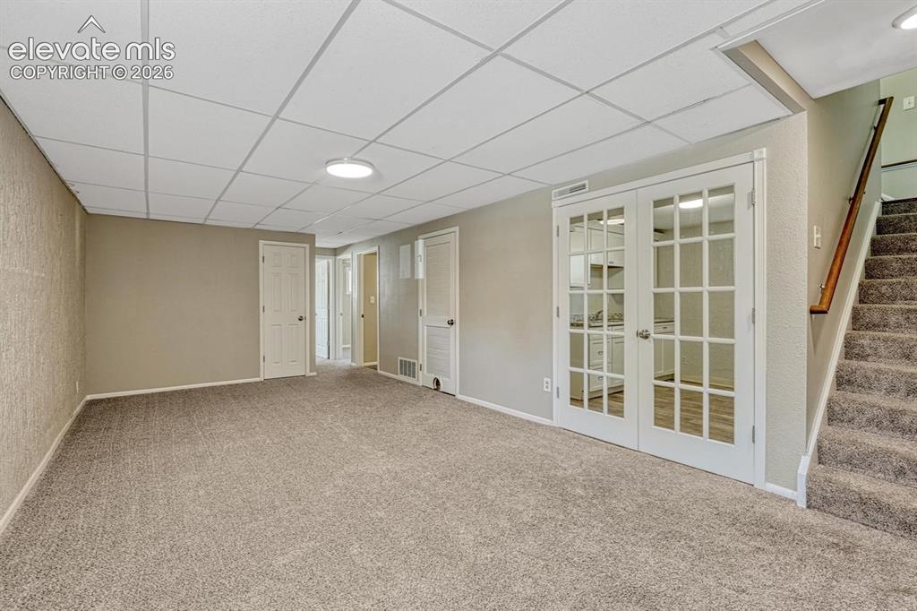 Image 15 of 29: Basement with two bedrooms and craft room with a sink and french doors!