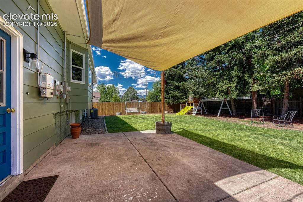 Image 25 of 29: Concrete patio featuring an overhead shade structure