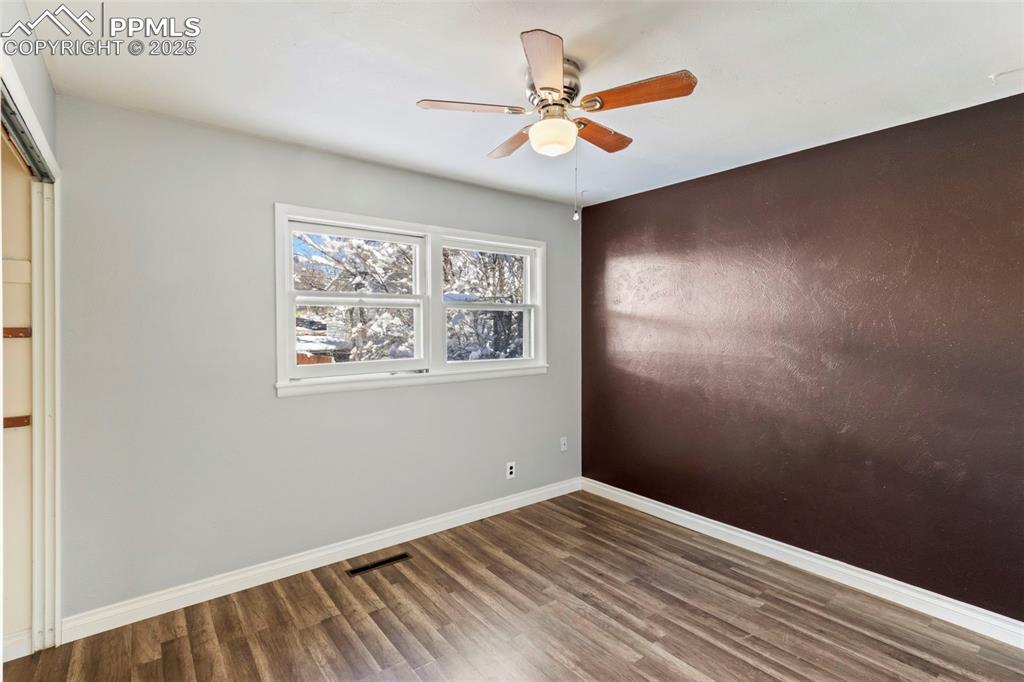 Image 12 of 25: Unfurnished bedroom featuring a closet, a ceiling fan, and wood finished fl