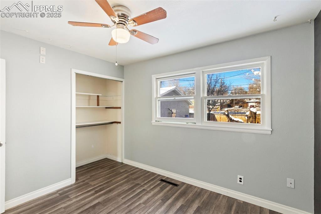 Image 13 of 25: Unfurnished bedroom with a closet, dark wood-type flooring, and a ceiling f