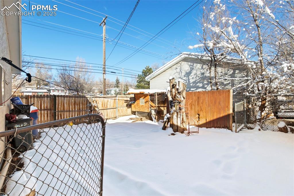 Image 23 of 25: View of fenced backyard