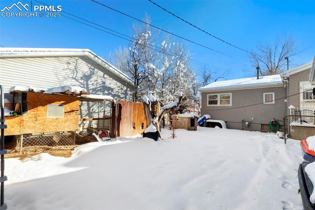 Image 25 of 25: View of yard covered in snow
