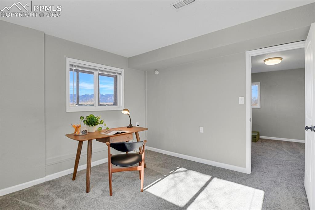 Image 22 of 47: Lower Level Bedroom #4, staged as an office