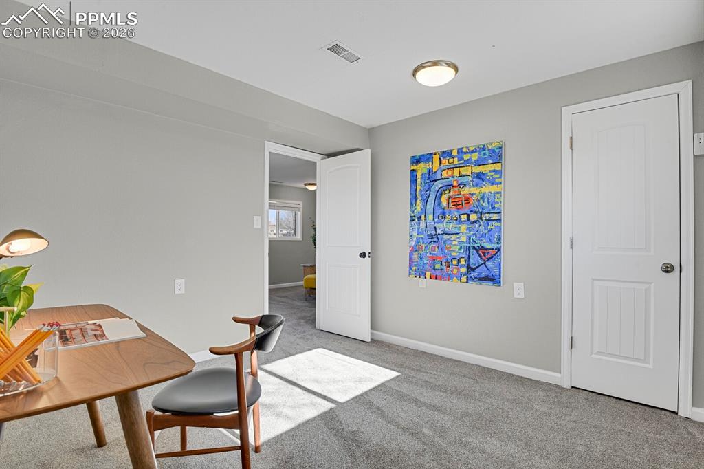 Image 23 of 47: Lower Level Bedroom #4, staged as an office