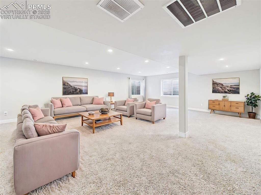 Image 28 of 50: Expansive basement living area, VIRTUALLY staged to highlight flexible spac