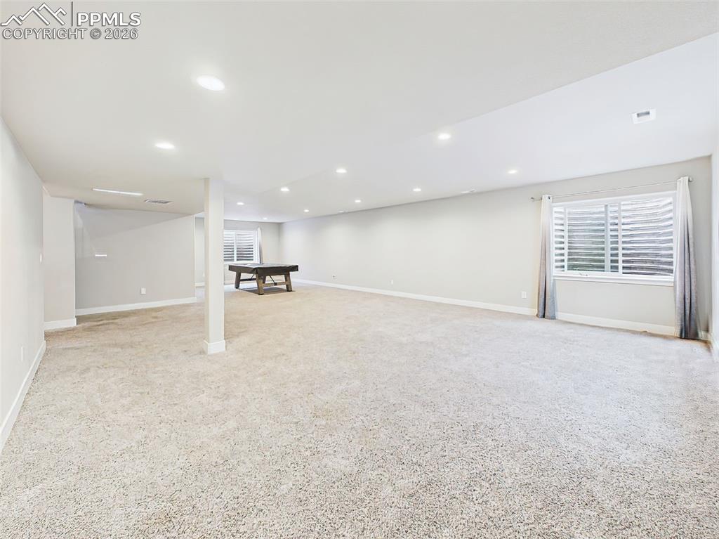 Image 29 of 50: Large finished basement view showcasing the scale and open layout with mult