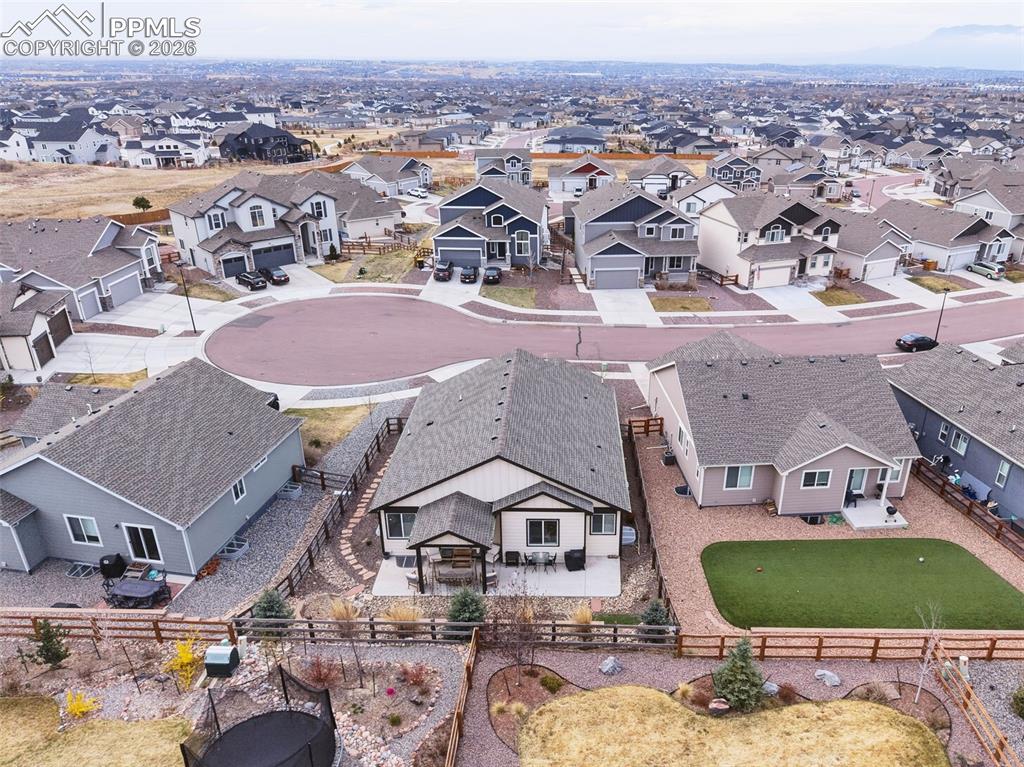 Image 3 of 50: Aerial view highlighting fenced backyard, covered patio, and surrounding ne