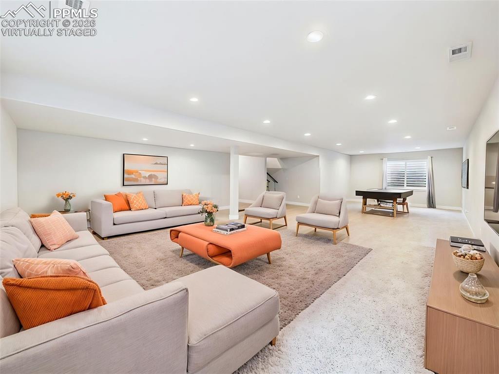 Image 32 of 50: VIRTUALLY staged basement perspective showing multiple functional zones inc