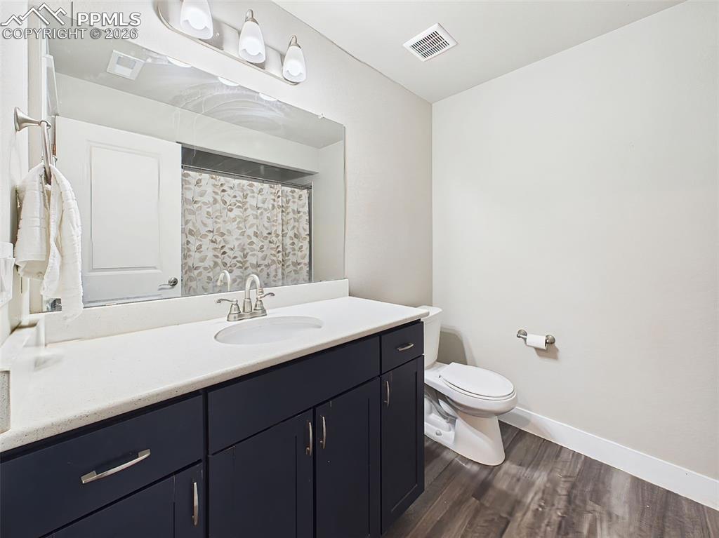 Image 34 of 50: Lower-level bathroom with modern vanity, large mirror, and clean finishes t