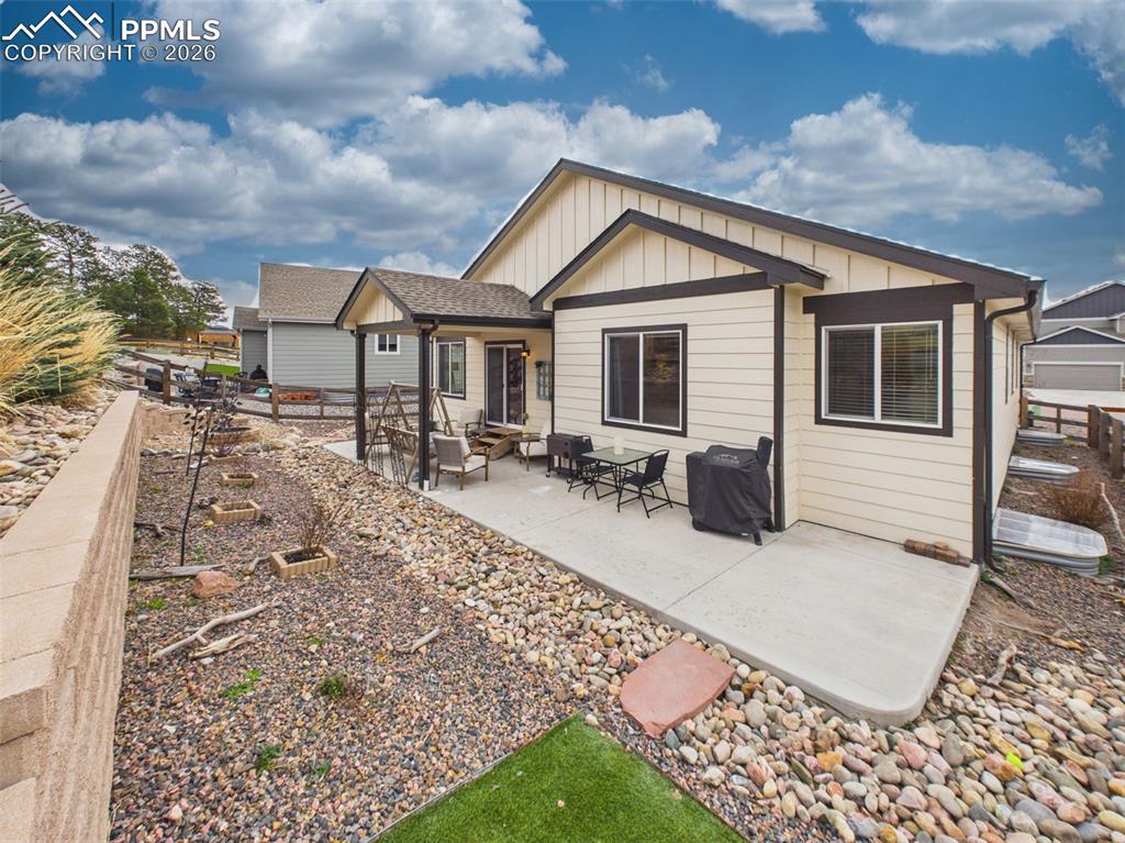 Image 39 of 50: Extended patio space offering multiple seating areas and room for outdoor d
