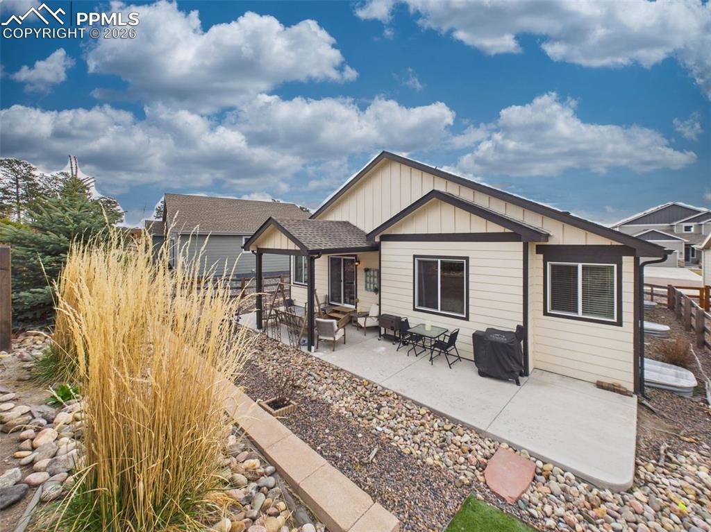 Image 40 of 50: Elevated backyard view showcasing tiered landscaping, open space, and surro