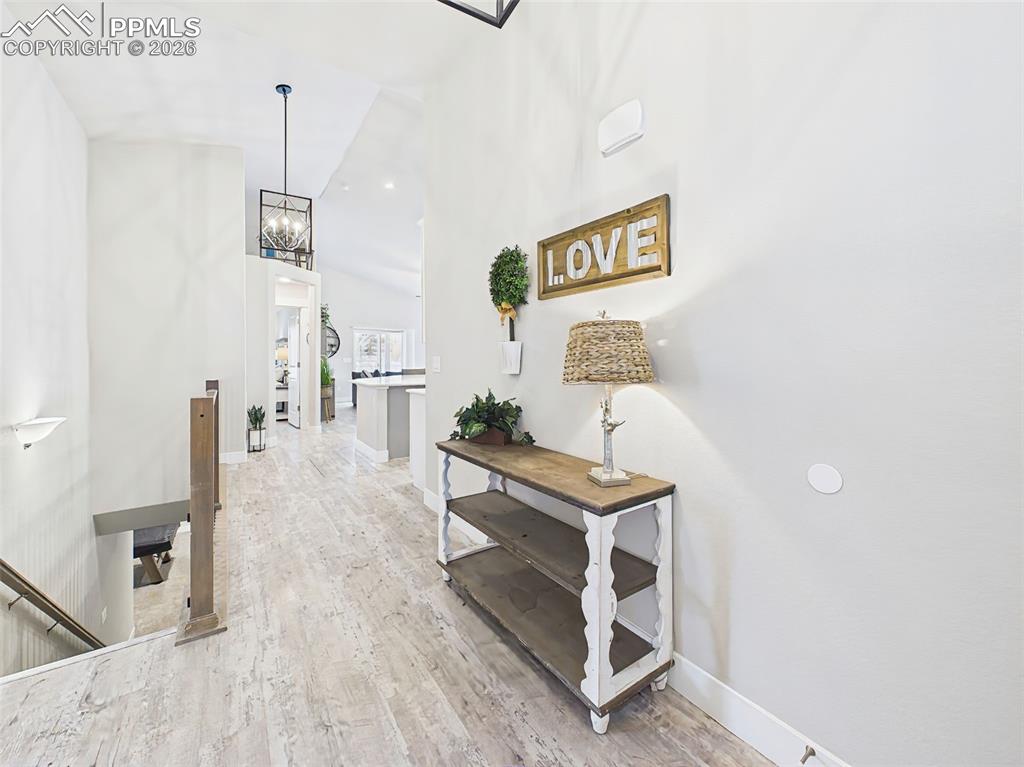 Image 7 of 50: Wide hallway with clean finishes, natural light, and open sightlines into m