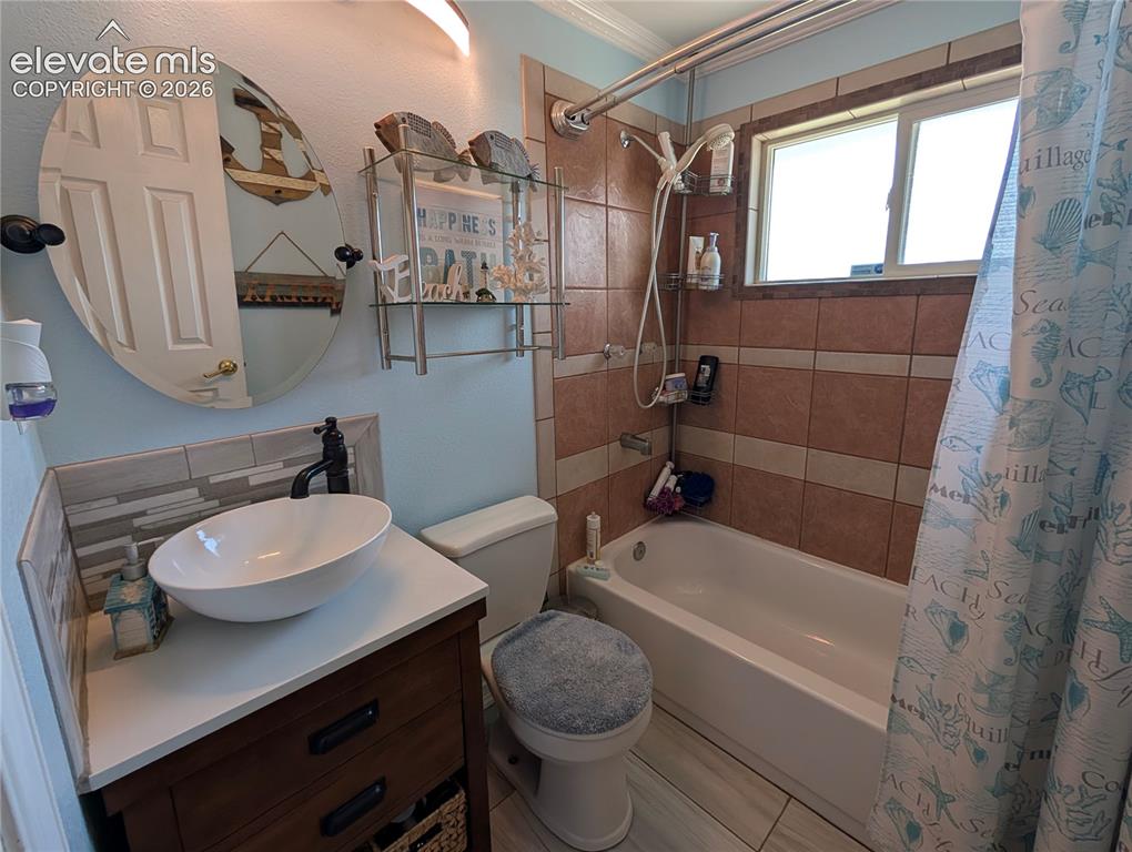 Image 11 of 20: Updated Bathroom with tile floor and surround