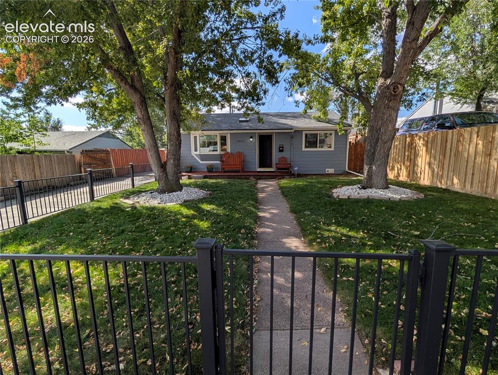 Image 19 of 20: nice fence in front yard with large shade trees