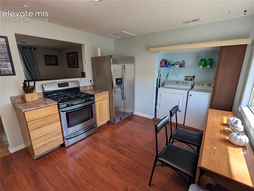 Image 2 of 20: Gas Range and Stainless Refrigerator