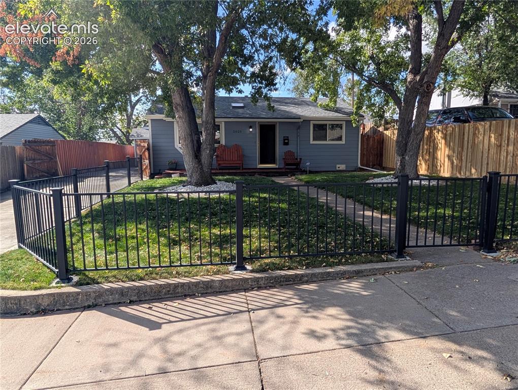 Image 20 of 20: nice fence in front yard with nice shade trees