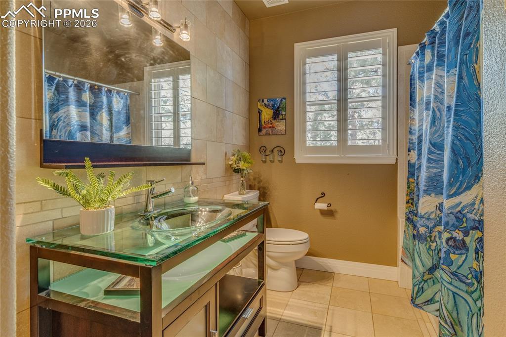 Image 14 of 50: Custom full main level bathroom.