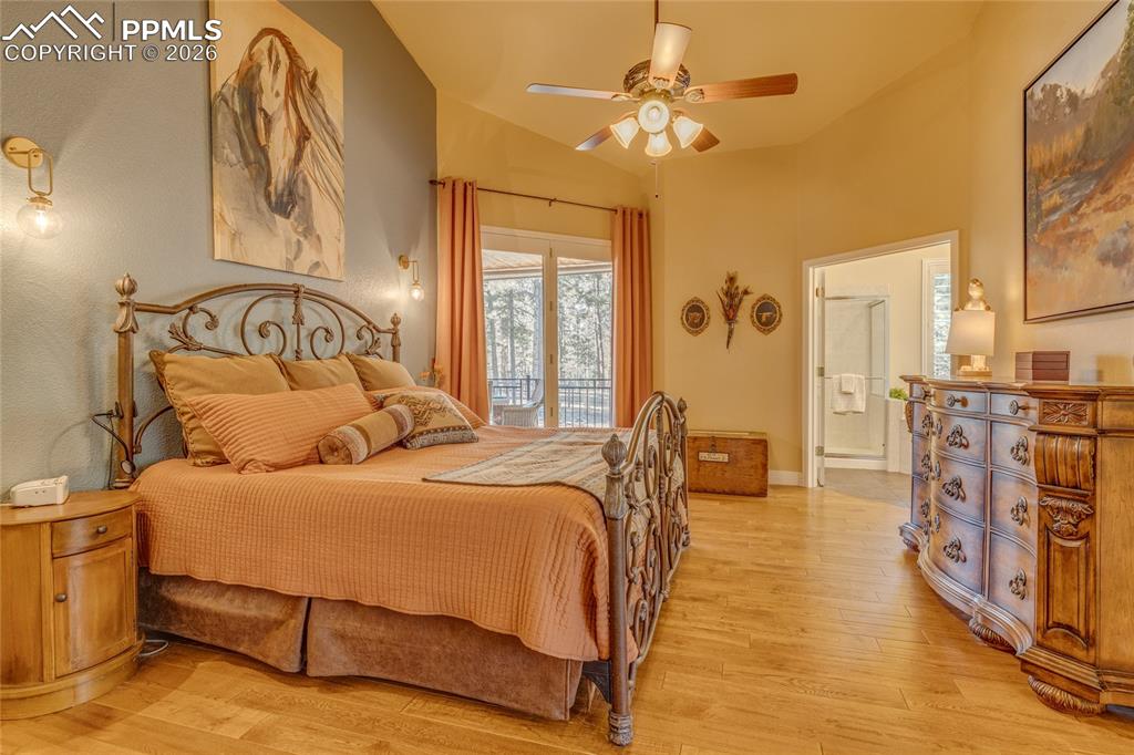 Image 17 of 50: Primary bedroom with sliding door accessing back covered deck.