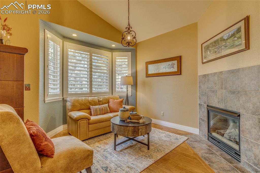 Image 18 of 50: Sitting area off Primary bedroom with gas fireplace.