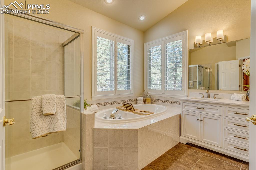 Image 21 of 50: Large soaking tub and walk in shower with corner windows.
