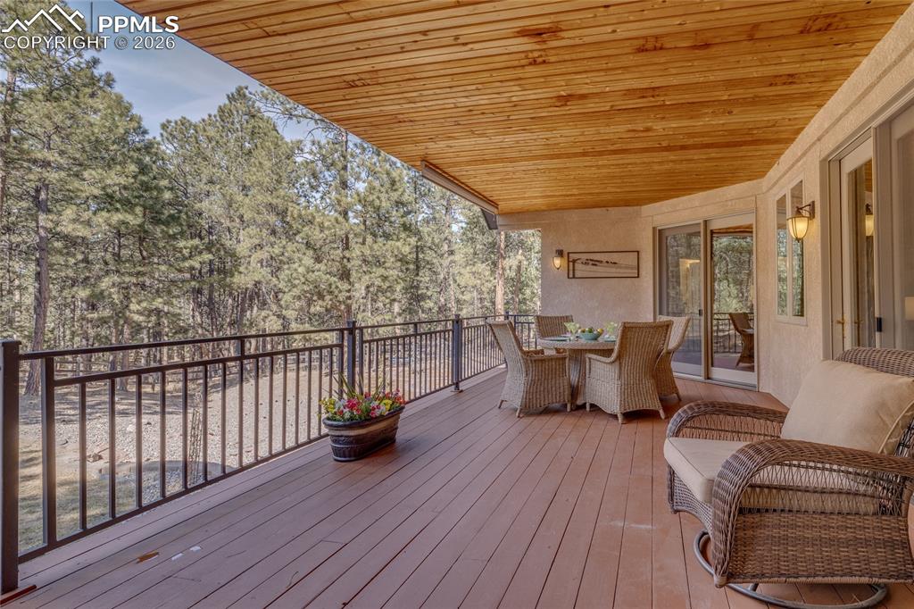 Image 22 of 50: Tongue-and-groove wood ceilings over 30x12 deck.