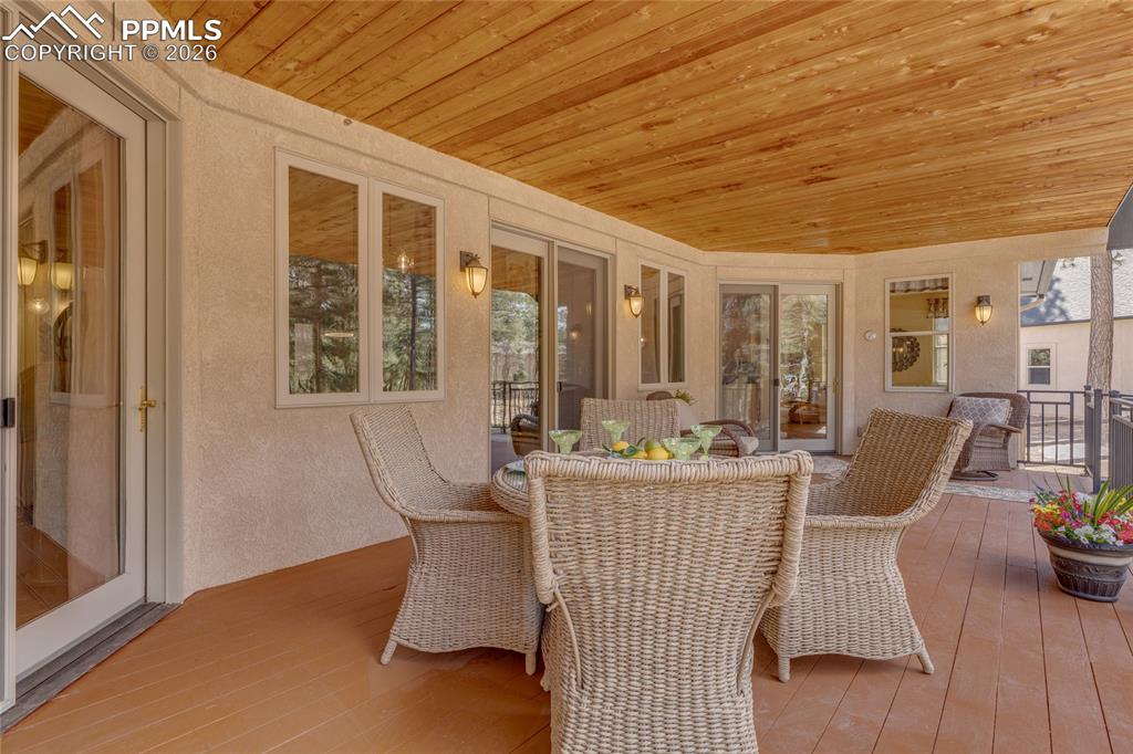Image 23 of 50: Entertain on the large wood deck. Easy access from kitchen, living room and